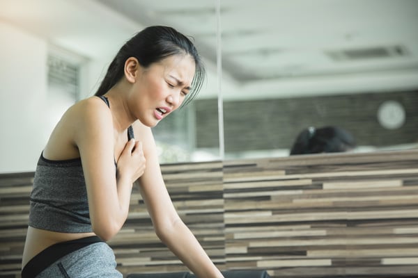 Asian-woman-having-heart-attack-after-workout.-684958042_1256x838