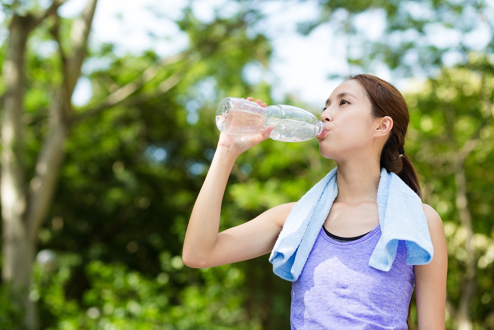 exercise woman drinking water stay hydrated thailand