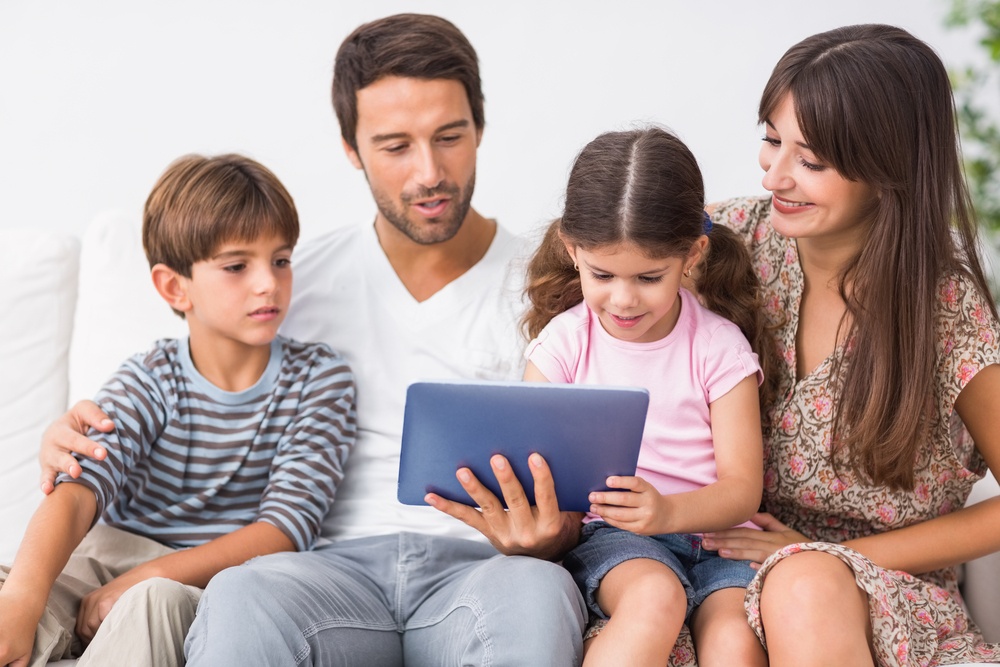 Happy family looking at tablet pc together