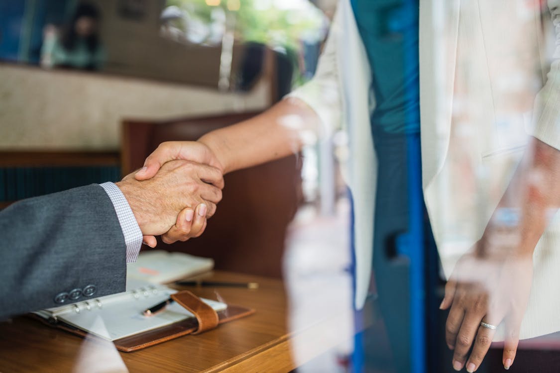 hand shake employee wellness hapiness